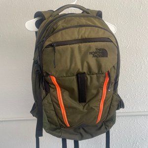 The North Face SURGE backpack in Forrest Night Green and Acrylic Orange